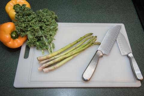 image tagged with vegetables, kale, greens, knives, cutting board, …;