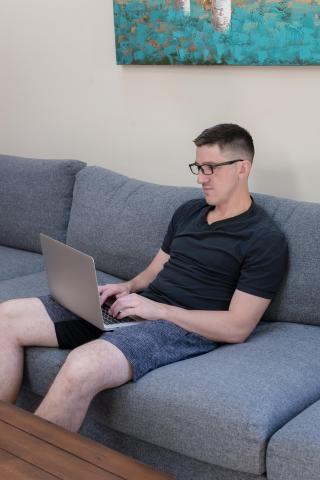 image tagged with man, looks, boy, sofa, laptop, …;