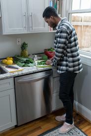 image tagged with cooking, broccoli, guy, cutting, kitchen, …;