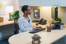 image tagged with glasses, desk, woman, works, african-american, …;