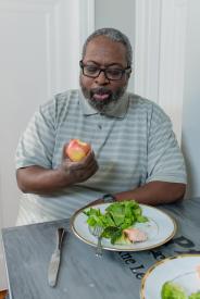 image tagged with eating, glasses, fork, knife, greens, …;