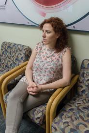 image tagged with sits, waiting, caucasian, patient, woman, …;