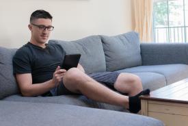 image tagged with glasses, male, sofa, man, sitting, …;