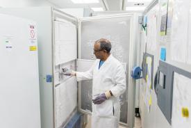 image tagged with researcher, middle aged, laboratory, touching, freezer, …;