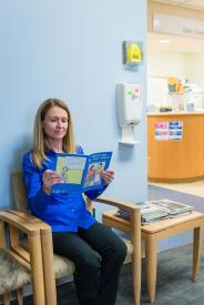 image tagged with doctor's office, woman, holding, reads, wait, …;