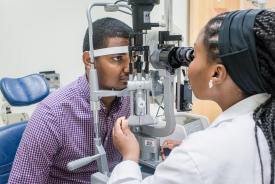 image tagged with african-american, exam room, patient, vision exam, eye exam, …;