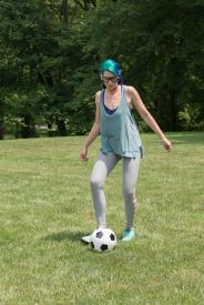 image tagged with kicks, ball, outdoors, glasses, field, …;