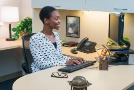 image tagged with african-american, desk, smiling, female, pencil, …;