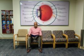 image tagged with adult, seated, waiting room, doctor's office, african-american, …;