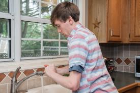 image tagged with kitchen, guy, sink, male, running water, …;