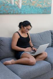 image tagged with typing, types, woman, working, couch, …;