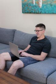 image tagged with glasses, computer, sitting, couch, look, …;