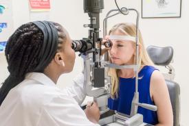 image tagged with check-up, slit lamp, caucasian, exam room, doctor, …;