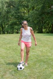 image tagged with kicking, playing, ball, latina, field, …;
