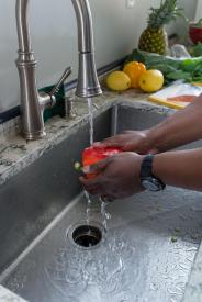 image tagged with running water, kitchen, hand, water, fruits, …;