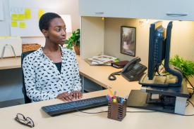 image tagged with smile, workplace, desk, female, african-american, …;