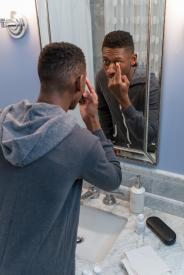 image tagged with african-american, restroom, eye care, man, mirror, …;