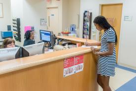 image tagged with patient, females, african-american, doctor's office, paperwork, …;