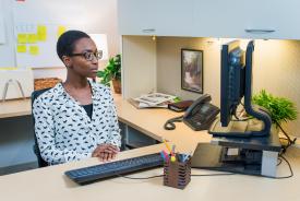 image tagged with sits, african-american, working, woman, desk, …;