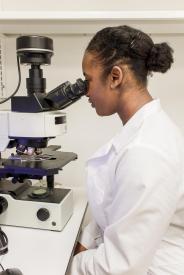 image tagged with machines, african-american, lab coat, female, microscope, …;