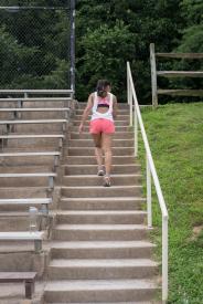 image tagged with woman, athletic, bleachers, female, stairs, …;