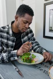 image tagged with fork, salmon, african-american, man, eating, …;