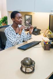 image tagged with workplace, keyboard, lady, african-american, chair, …;