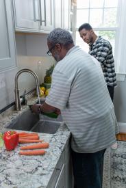 image tagged with rinse, kitchen, wash, african-american, food prep, …;