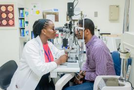 image tagged with vision exam, female, medical device, medical care, african-american, …;