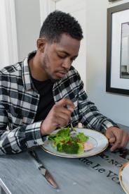 image tagged with knife, sits, african-american, greens, fork, …;