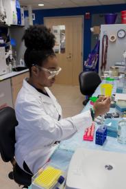 image tagged with lab coat, tube, holds, equipment, african-american, …;