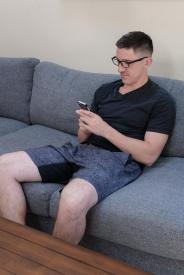 image tagged with look, guy, couch, sits, holds, …;