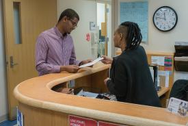 image tagged with woman, paperwork, help, african-american, clinic, …;