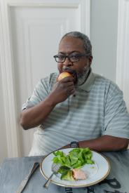 image tagged with guy, african-american, biting, meal, glasses, …;