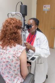 image tagged with patient, women, african-american, vision, exam, …;