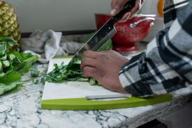 image tagged with leafy greens, counter, food, strainer, hands, …;