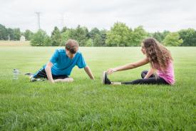 image tagged with exercise, stretching, park, sister, field, …;