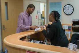 image tagged with doctor's appointment, female, talking, check in, african-american, …;