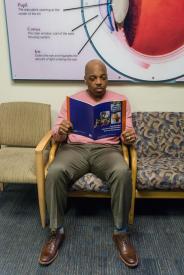 image tagged with sit, reading, man, doctor's office, chairs, …;