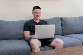 image tagged with looks, couch, man, boy, sits, …;