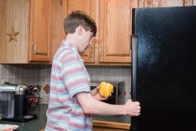 image tagged with refrigerator, man, kitchen, stand, vegetable, …;