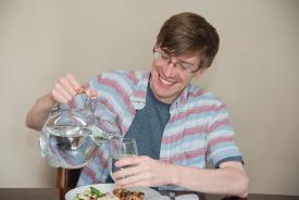 image tagged with caucasian, pouring water, smiling, man, glasses, …;