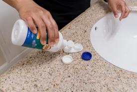 image tagged with caps, cleaning solution, hands, counter, pour, …;