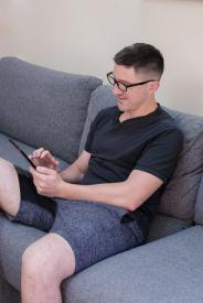 image tagged with sofa, glasses, typing, millennial, sits, …;