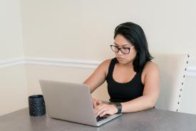 image tagged with asian-american, laptop, glasses, female, sit, …;