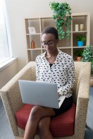image tagged with screen, sits, lady, african-american, computer, …;
