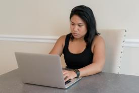 image tagged with conference room, laptop, female, asian-american, typing, …;