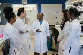 image tagged with professor, talk, african-american, interns, lab coat, …;