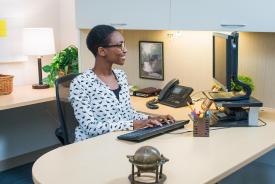 image tagged with african-american, sitting, workplace, woman, phone, …;