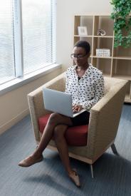 image tagged with woman, african-american, computer, sit, chair, …;